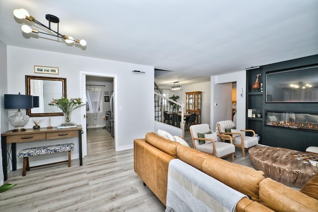 living room with a chandelier and light wood-type flooring