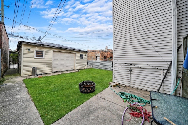 view of yard with a fire pit, an outdoor structure, and a garage