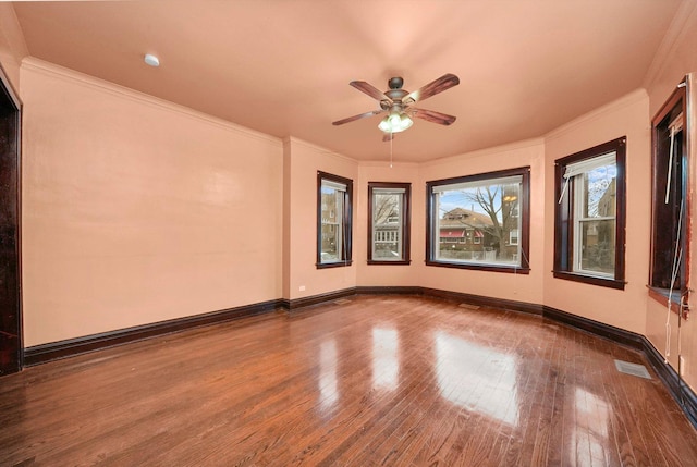 unfurnished room with hardwood / wood-style flooring, ceiling fan, and crown molding