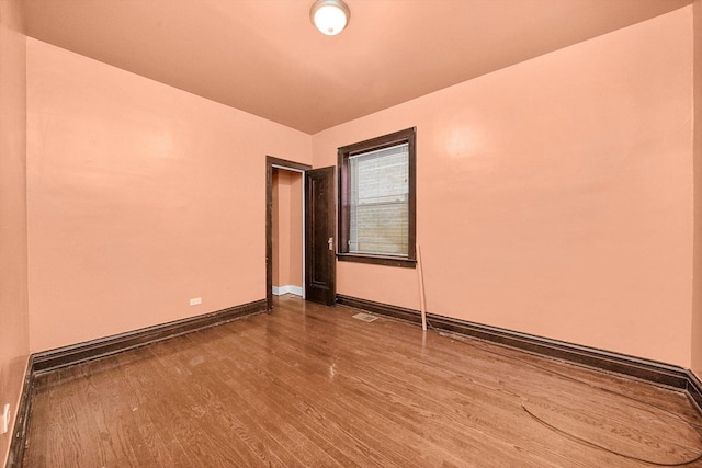 spare room featuring hardwood / wood-style flooring