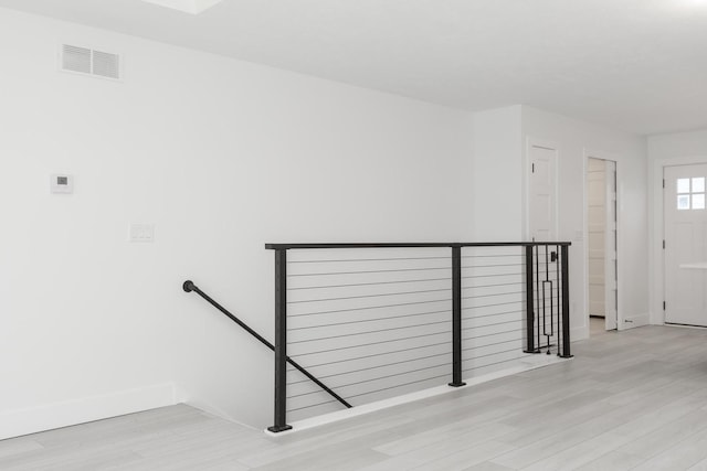 stairway with hardwood / wood-style flooring