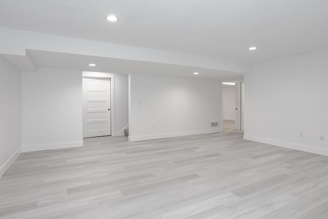 basement with light hardwood / wood-style floors