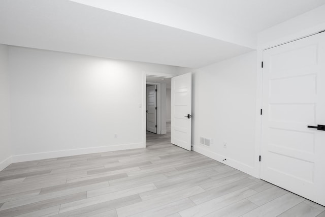 unfurnished room with light wood-type flooring