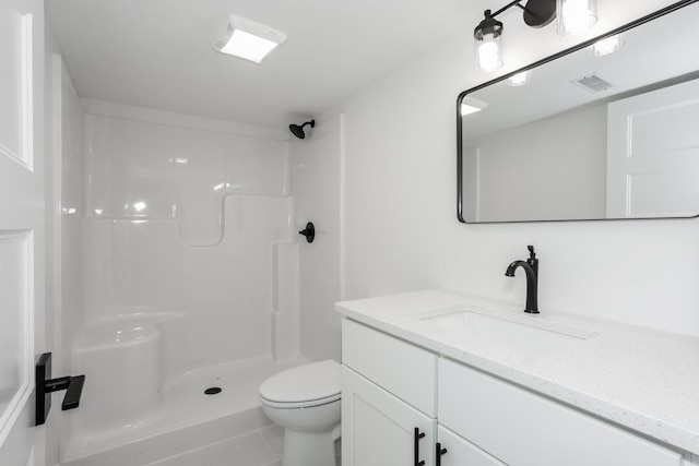 bathroom featuring toilet, tile patterned flooring, vanity, and walk in shower