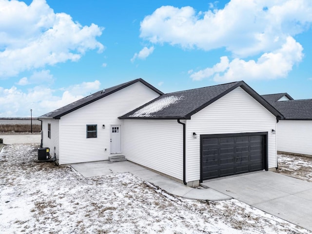 exterior space featuring a garage and central AC unit