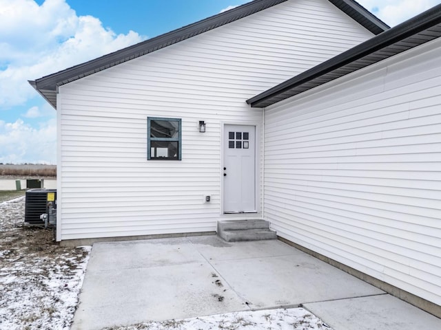 property entrance with central AC unit and a patio area