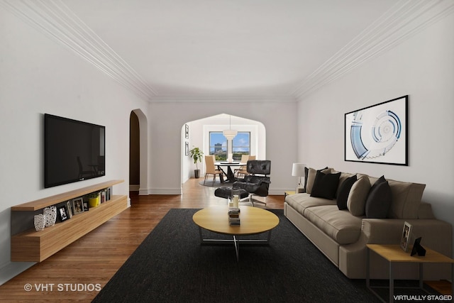 living room with hardwood / wood-style floors and crown molding