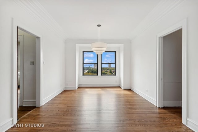 unfurnished dining area with hardwood / wood-style floors and crown molding