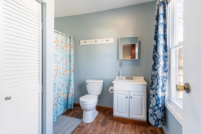 full bathroom featuring baseboards, plenty of natural light, toilet, and wood finished floors