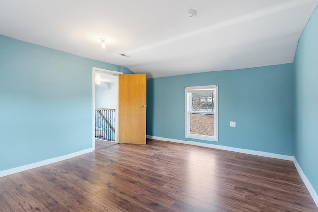 unfurnished room with wood finished floors and baseboards