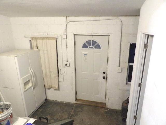 laundry room featuring concrete block wall