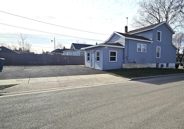 exterior space with fence and a chimney