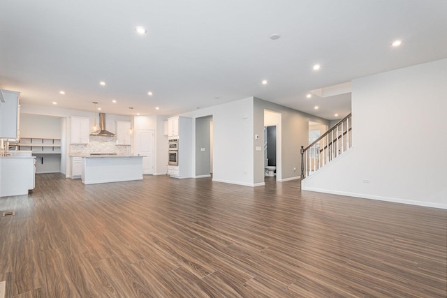 unfurnished living room with dark hardwood / wood-style floors