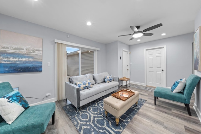 living room featuring ceiling fan and hardwood / wood-style floors