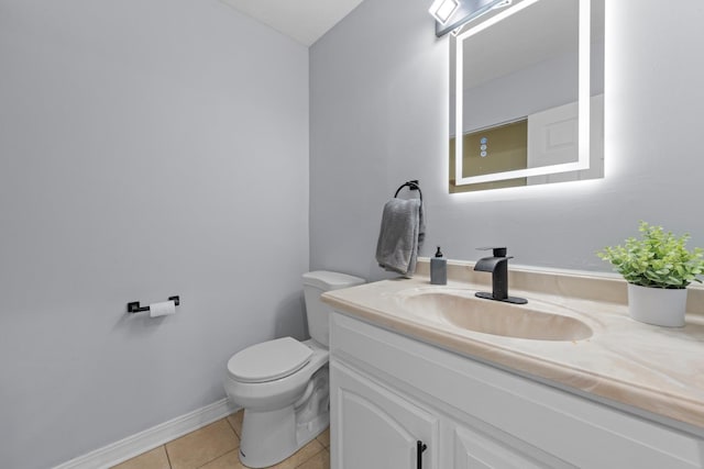 bathroom with tile patterned floors, vanity, and toilet