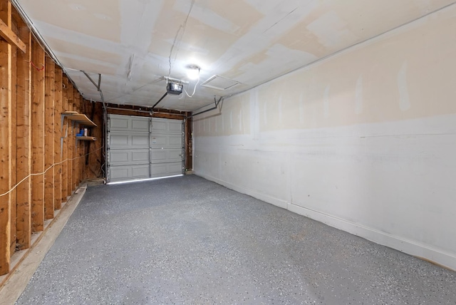 garage with wooden walls and a garage door opener