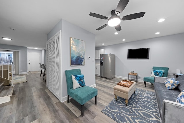 living room with hardwood / wood-style flooring and ceiling fan