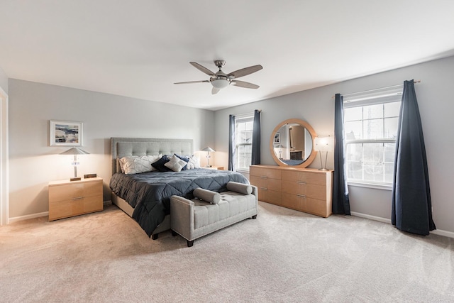 carpeted bedroom with ceiling fan and multiple windows