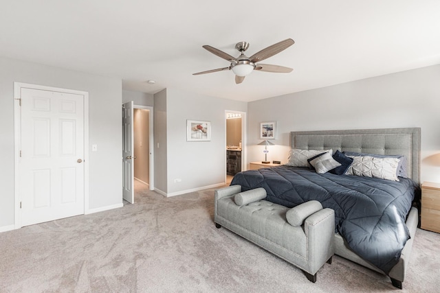 bedroom featuring ceiling fan, ensuite bathroom, and light carpet