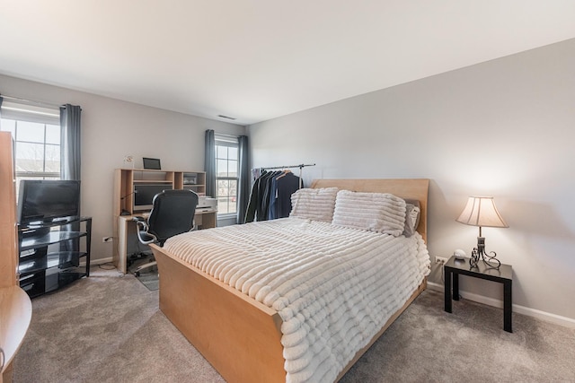 bedroom with multiple windows and carpet