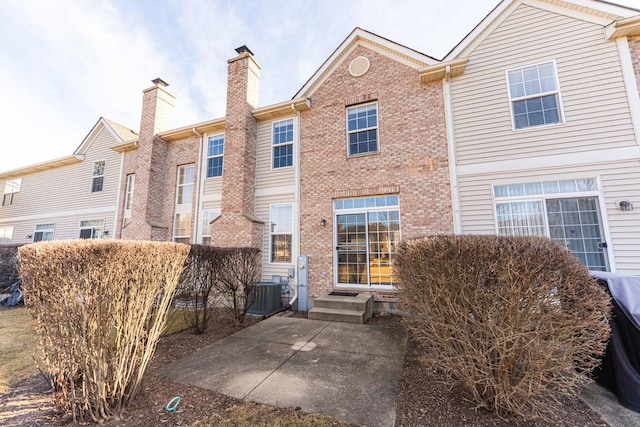 back of property featuring central AC and a patio area