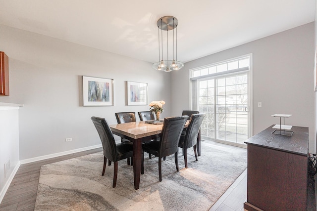 dining space with wood-type flooring