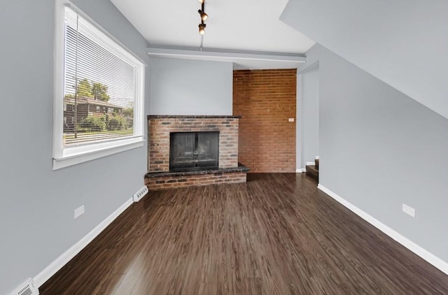 unfurnished living room with a fireplace and dark hardwood / wood-style flooring