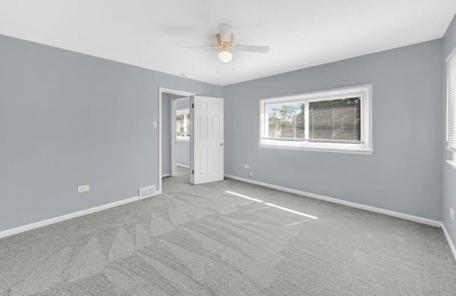 unfurnished bedroom with light colored carpet and ceiling fan