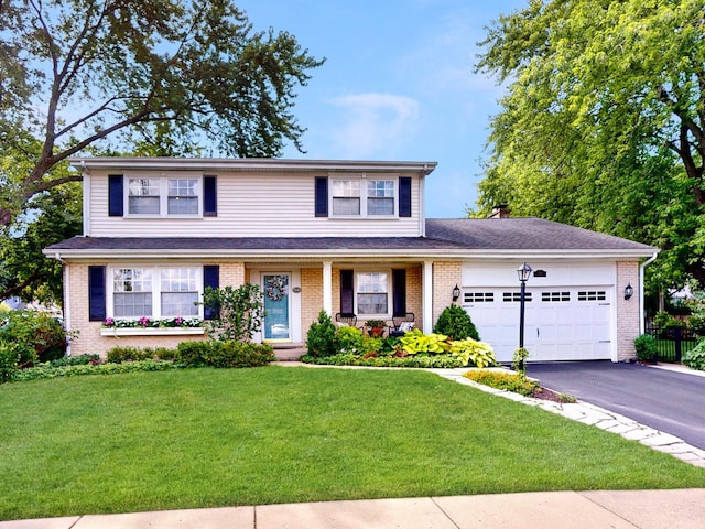 view of front of home with a garage and a front lawn