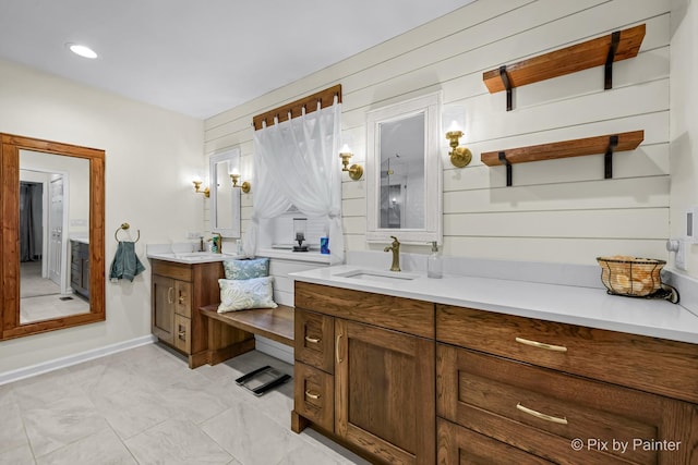 bathroom featuring vanity and wooden walls