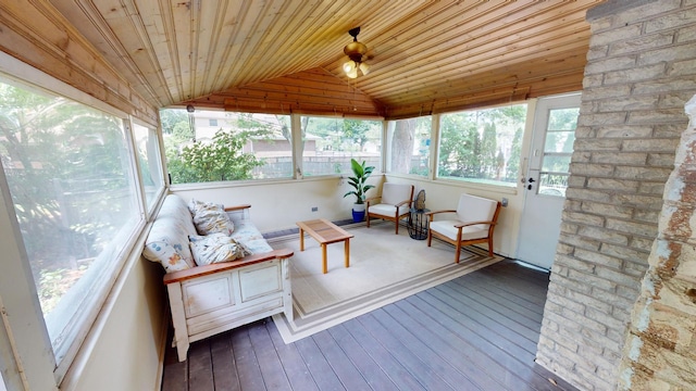 sunroom with ceiling fan, plenty of natural light, wood ceiling, and vaulted ceiling