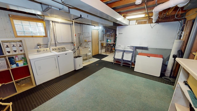 basement featuring washing machine and clothes dryer and dark carpet