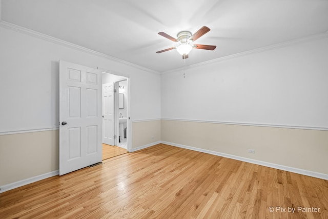 empty room featuring ceiling fan, light hardwood / wood-style flooring, and ornamental molding