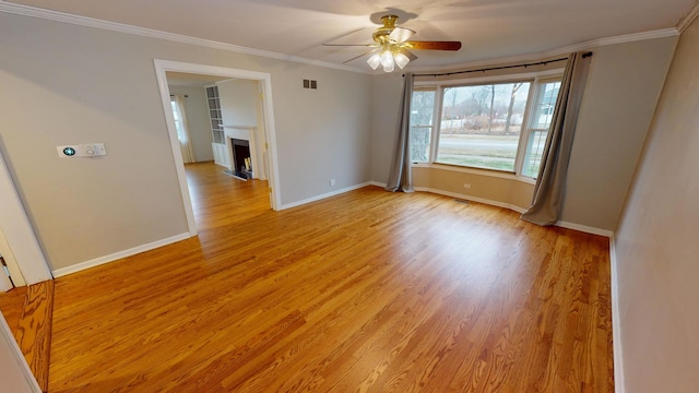 unfurnished room with ceiling fan, ornamental molding, and light hardwood / wood-style flooring