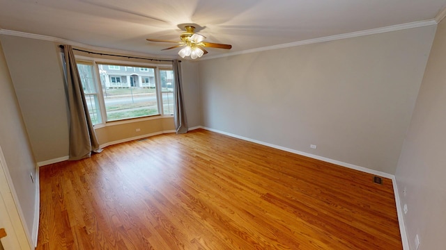 empty room with ceiling fan, ornamental molding, and light hardwood / wood-style flooring