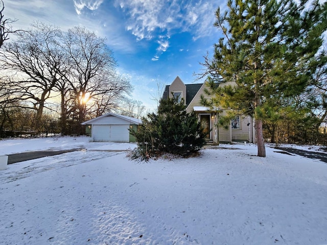 obstructed view of property featuring a garage and an outbuilding