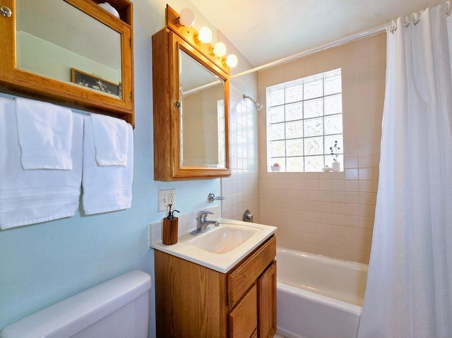 full bathroom featuring vanity, shower / bath combination with curtain, and toilet