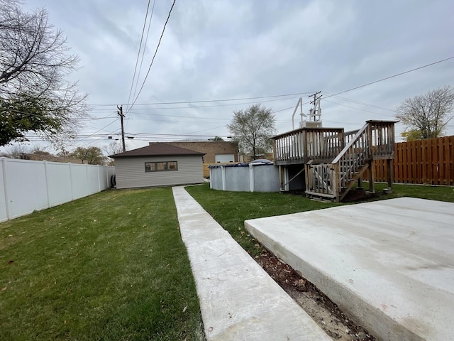 view of yard with a pool side deck and a patio