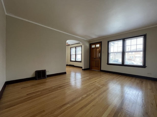 entrance foyer featuring plenty of natural light, light hardwood / wood-style floors, and ornamental molding