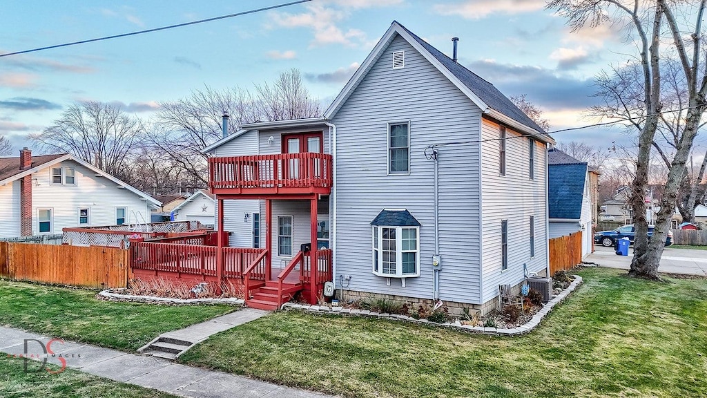 view of front of house with a yard and a deck