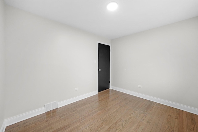 spare room featuring light hardwood / wood-style floors