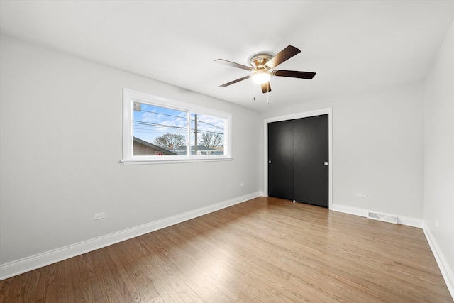 unfurnished room featuring ceiling fan and light wood-type flooring