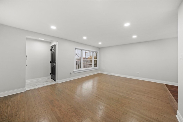 unfurnished room with wood-type flooring