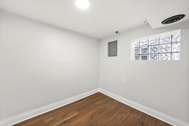 spare room with hardwood / wood-style flooring and electric panel