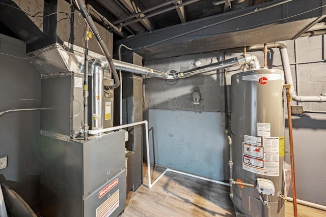 utility room with heating unit and water heater