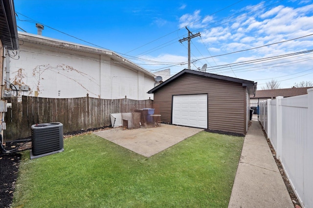 garage with central AC and a yard