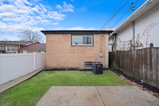 rear view of house featuring a yard and cooling unit