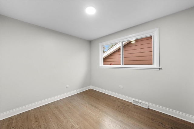 empty room featuring hardwood / wood-style flooring