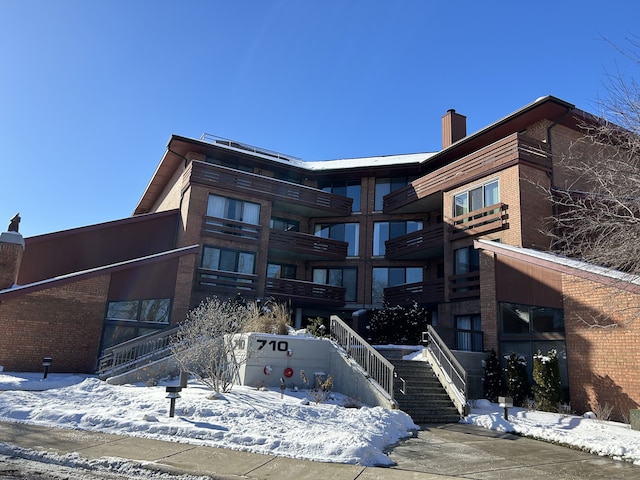 view of snow covered rear of property