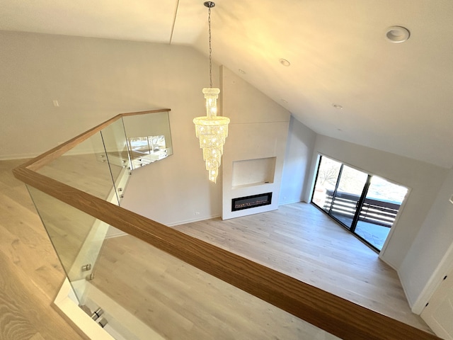 unfurnished living room featuring hardwood / wood-style floors and vaulted ceiling